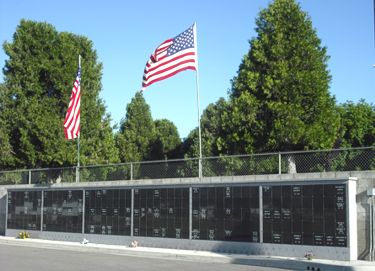 Photograph of Outdoor Cremation Niche Wall and Amercian Flags